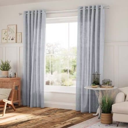 Layered drapery and sheer curtains in a living room